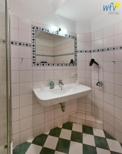 a bathroom with a sink and a mirror at Villa Cila Ferienwohnung 3 in Wangerooge