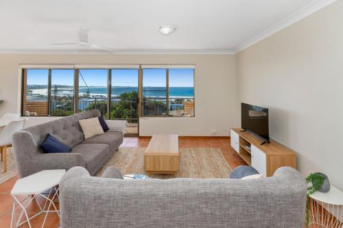 a living room with a couch and a tv at Sea Gaze 4 - With Remarkable Ocean Views in Kingscliff