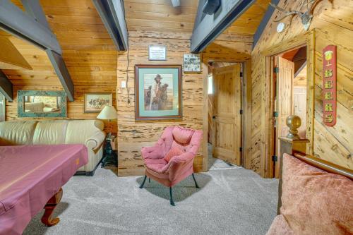 a bedroom with wooden walls and a pink chair at 10 Mi to Lake Tahoe Beaches Home with Pool Table in South Lake Tahoe