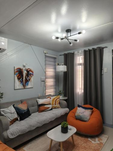 a living room with a couch and a table at 2BR FULL Airconditioned Spacious-Cozy &Relaxing in Davao City