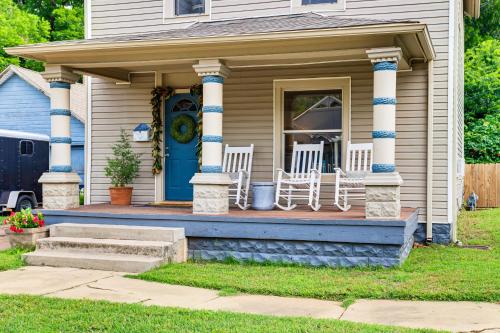 a house with two chairs and a blue door at Walk to Downtown Historic Guthrie Home on Mansur in Guthrie