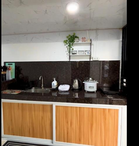a kitchen with a sink and a counter top at 2BR FULL Airconditioned Spacious-Cozy &Relaxing in Davao City