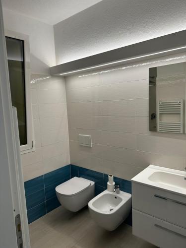 a bathroom with a white toilet and a sink at House in Paradise in Moneglia