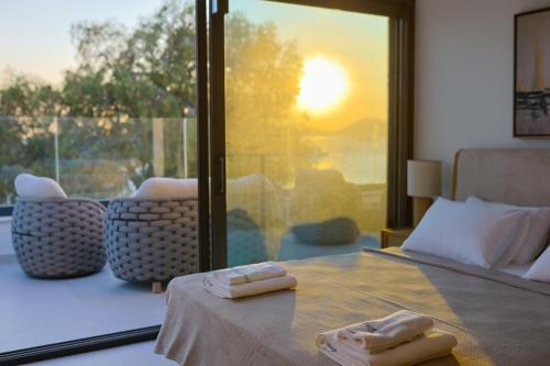 a bedroom with a bed with two towels on a table at Blue Point Hotel Yalikavak in Yalıkavak