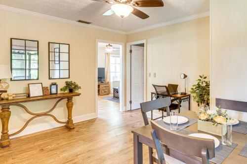 a dining room and living room with a table and chairs at 1 Mi to Dtwn Waycross Home with Furnished Porch in Waycross
