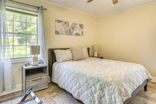 a bedroom with a bed and a window at 1 Mi to Dtwn Waycross Home with Furnished Porch in Waycross