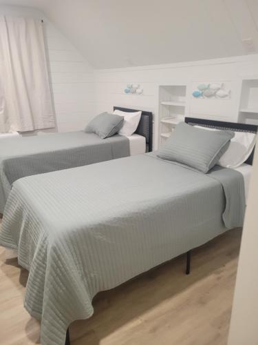 two beds sitting next to each other in a room at Adventure Awaits in Beaufort
