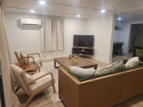 a living room with a couch and a tv at Adventure Awaits in Beaufort