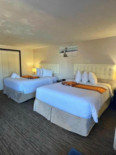 a hotel room with two beds in a room at Cape Sands Inn in West Yarmouth