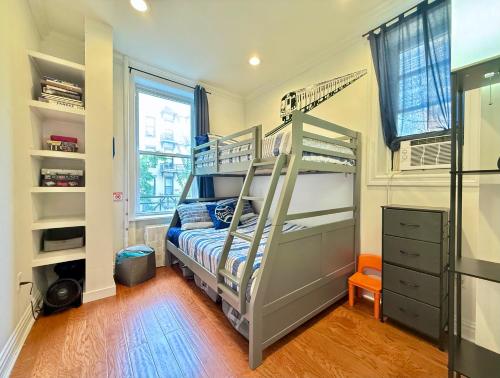 a bedroom with two bunk beds and a window at 15 Minutes to NYC - Large Home - Great Location in Hoboken