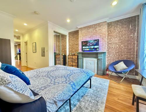 a bedroom with a bed and a brick wall at 15 Minutes to NYC - Large Home - Great Location in Hoboken