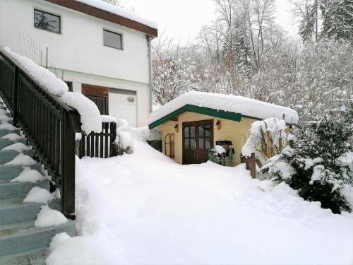 a house covered in snow next to a house at Yannsa in Untertweng