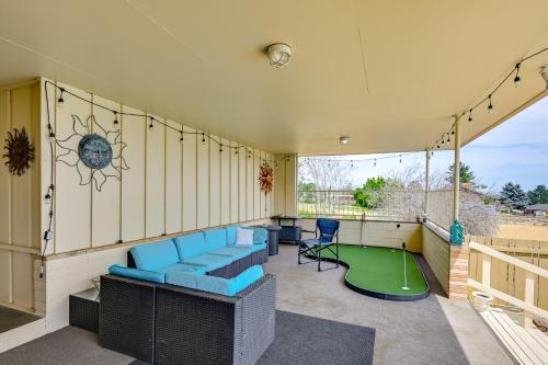 a patio with blue chairs and a miniature golf at Family-Friendly Yakima Escape with Yard and Pool! in Yakima