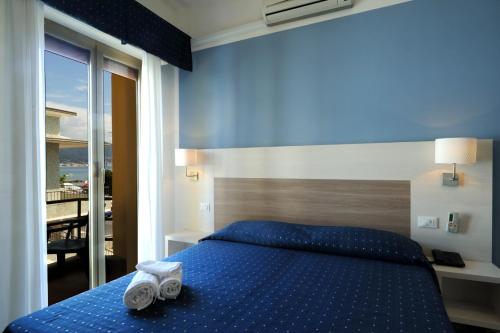 Postel nebo postele na pokoji v ubytování Hotel Delfino