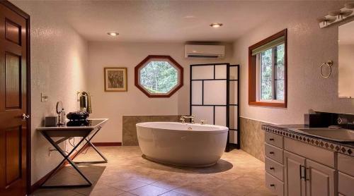 a large bathroom with a tub and a sink at Waterfront Hood Canal-Private Beach-Boat-Kayaks in Brinnon