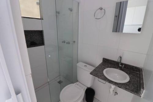 a bathroom with a shower and a toilet and a sink at Loft Murano in Paulínia