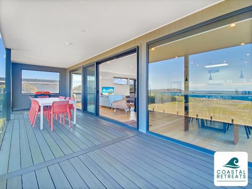 a dining room with a table and a view of the ocean at Alonda - Ocean Views in San Remo