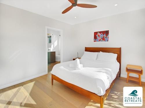 a bedroom with a bed with a ceiling fan at Alonda - Ocean Views in San Remo