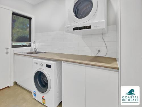 a kitchen with a washing machine and a sink at Alonda - Ocean Views in San Remo