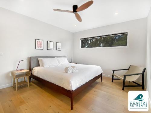 a bedroom with a bed and a ceiling fan at Alonda - Ocean Views in San Remo