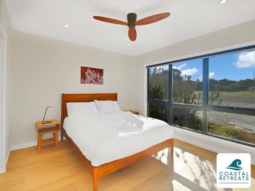 a bedroom with a bed and a large window at Alonda - Ocean Views in San Remo