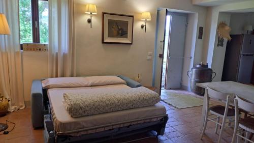 a room with two beds and a table in it at Appartamento Holly House in Radda in Chianti