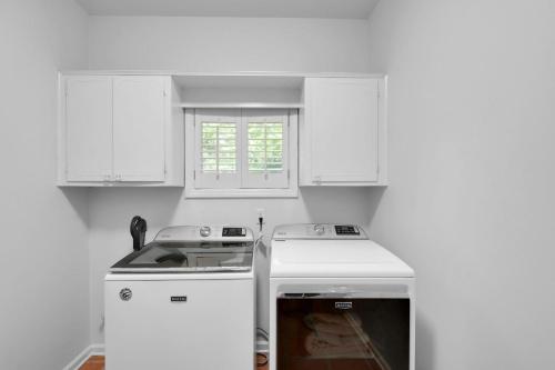 a kitchen with white cabinets and a stove top oven at 4310 Ninth Street in Saint Simons Island