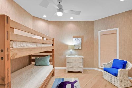 a bedroom with a bunk bed and a chair at 4310 Ninth Street in Saint Simons Island