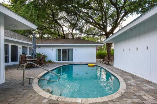 a swimming pool in front of a house at 4310 Ninth Street in Saint Simons Island