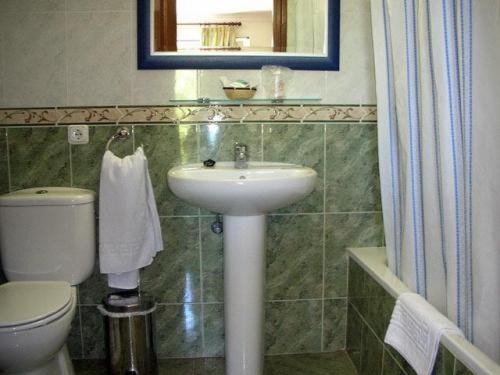 a white toilet sitting next to a sink in a bathroom at Don Alfredo in Marbella