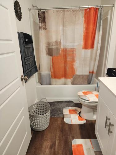 a bathroom with a toilet and a shower at Private Cozy Room and Bathroom in Home near Seaworld Riverwalk and AFB in San Antonio
