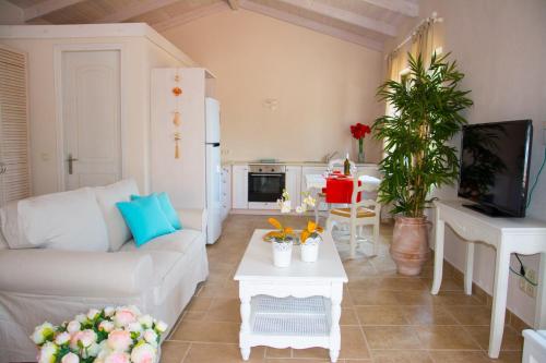 a living room with a couch and a table at Ideales Resort in Trapezaki