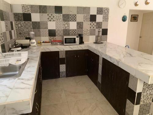 a kitchen with a sink and a counter top at Casa fraccionamiento colonos Ticuman in Ticumán