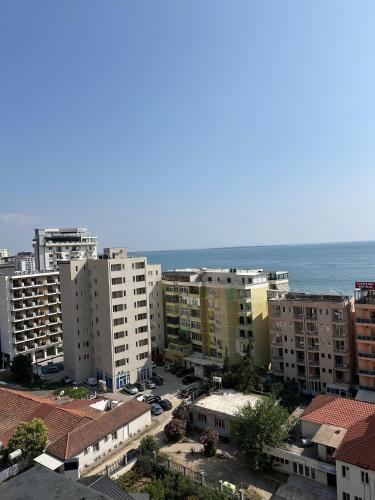 a view of a city with buildings and the ocean at Sol & Sea Apartments in Shëngjin
