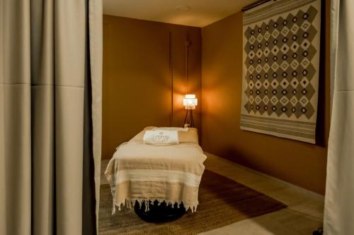 a bedroom with a bed with a lamp on it at Boutique Hotel Caramel in Syvota