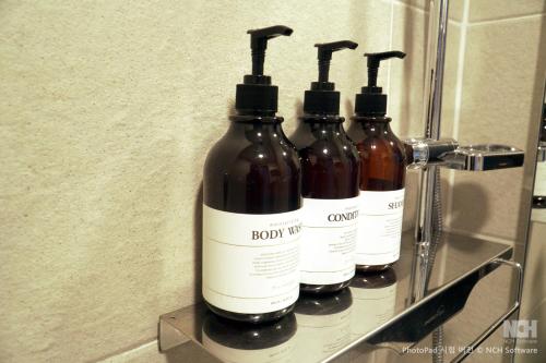 a group of four bottles sitting on a shelf at Hotel Iam in Suncheon
