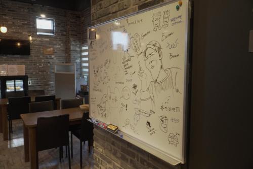 a wall with drawings on it in a restaurant at Hotel Iam in Suncheon