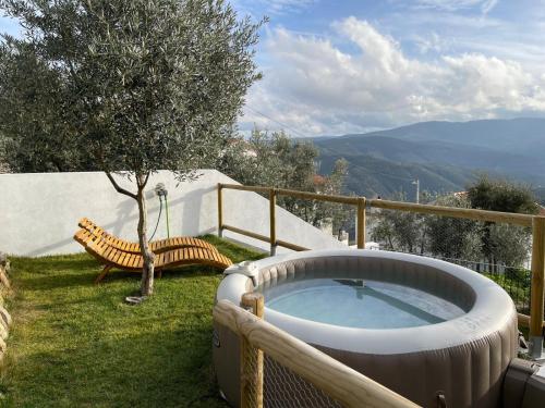a hot tub on the side of a yard with a bench at Serradinho Country House 