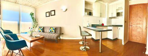 a kitchen and living room with a table and chairs at Departamento Buena vista in Talca