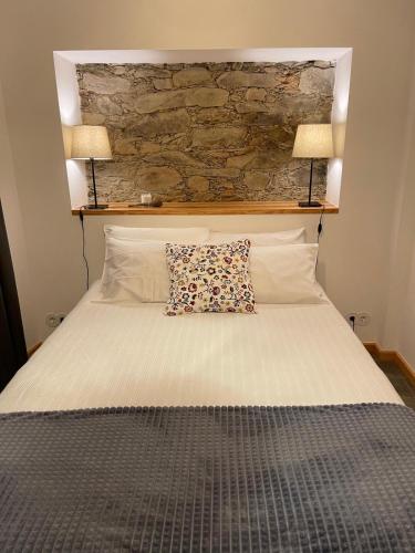 a bed with a pillow on top of it at Serradinho Country House 