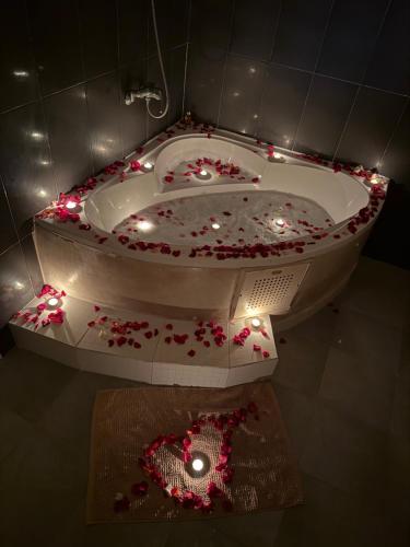 a bathroom with a tub covered in flower petals at Serenity Mogador in Essaouira