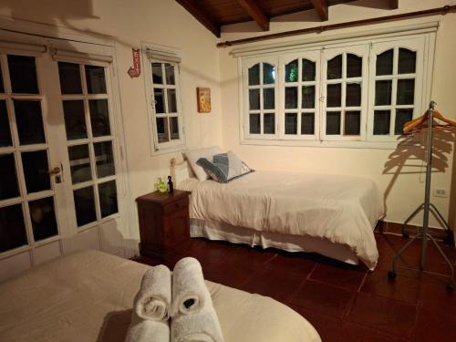 a bedroom with two beds with towels on the floor at Un espacio en la naturaleza in Salta