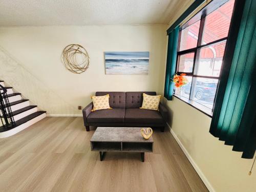 a living room with a couch and a table at Cozy Corner Home Stay in Philadelphia