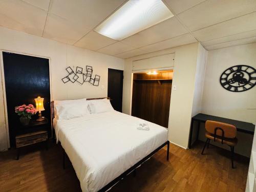 a bedroom with a white bed and a chair at Cozy Corner Home Stay in Philadelphia