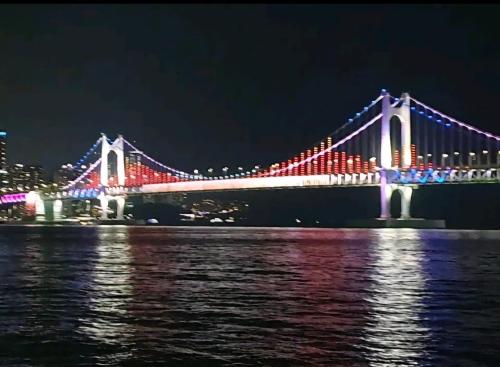 a bridge lit up at night with lights at 에벤에셀 in Busan