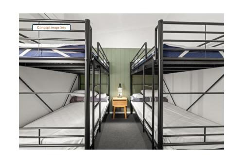 two bunk beds in a room with a table at Discovery Parks - Clare in Clare