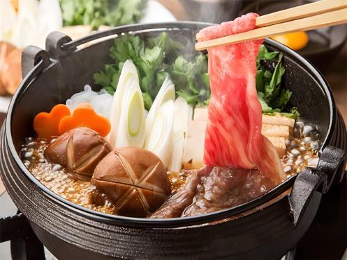 a pot of soup with meat and vegetables in it at LiVEMAX RESORT Setouchi Sea Front in Tatsuno