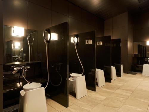 a bathroom with a row of toilets in a room at CROSS Life Hakata Tenjin in Fukuoka
