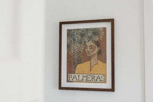 a framed picture of a man on a wall at Private & Stylish Hinterland Cottage in Gold Coast