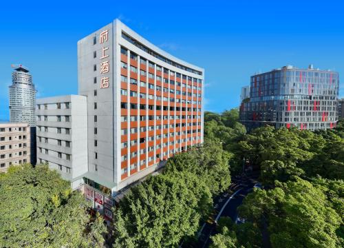 an aerial view of a tall building with trees at Fushang Hotel (Railway Station Yuexiu Park Sun Yatsen Memorial Hall Branch) in Guangzhou
